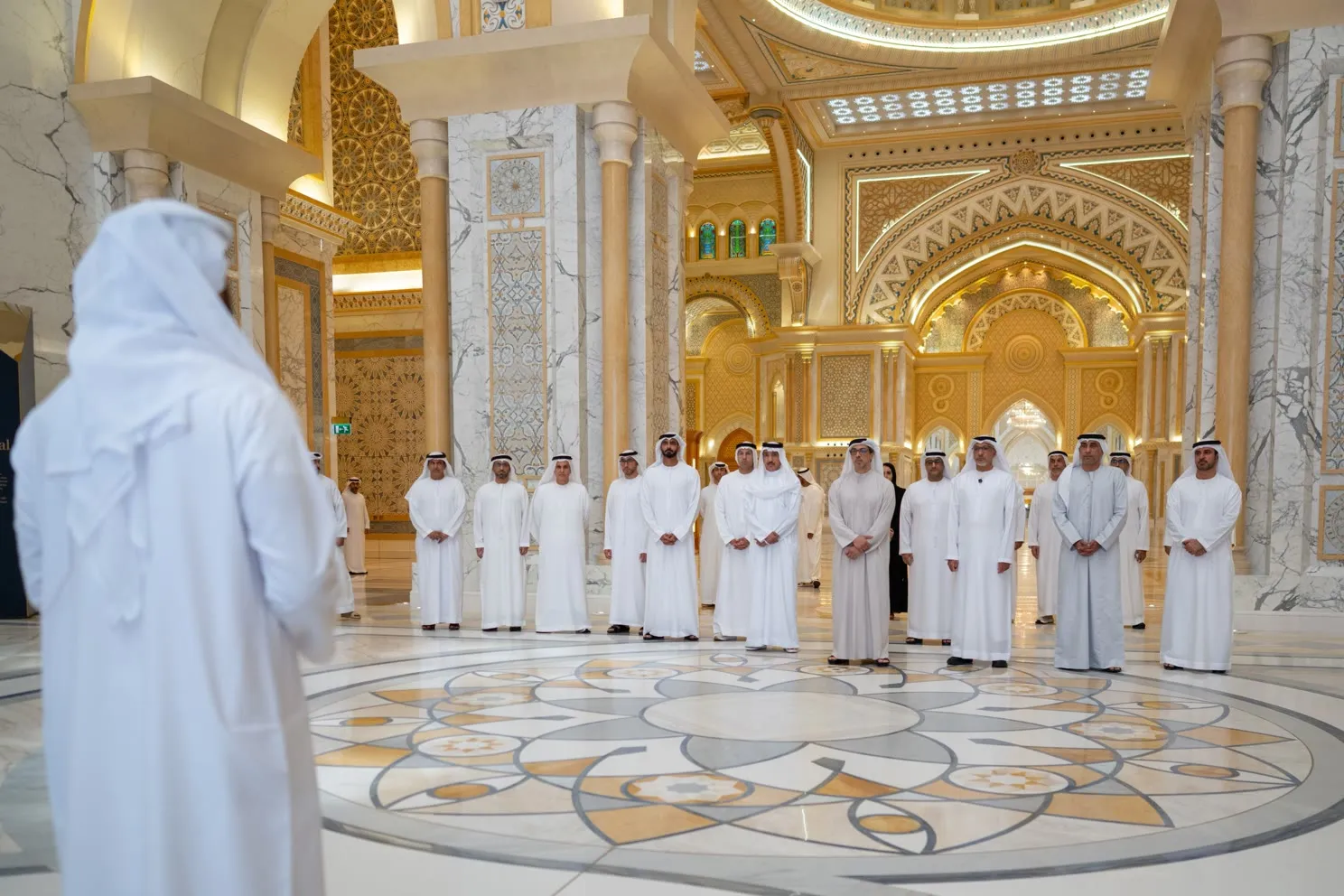 Guests at the official opening, gathered on the inlaid marble floor of the palace's main hall