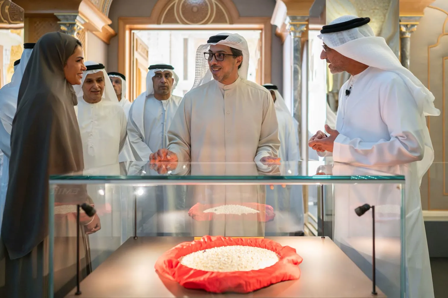 A mound of pearls on red cloth in a showcase, shown to guests during the opening